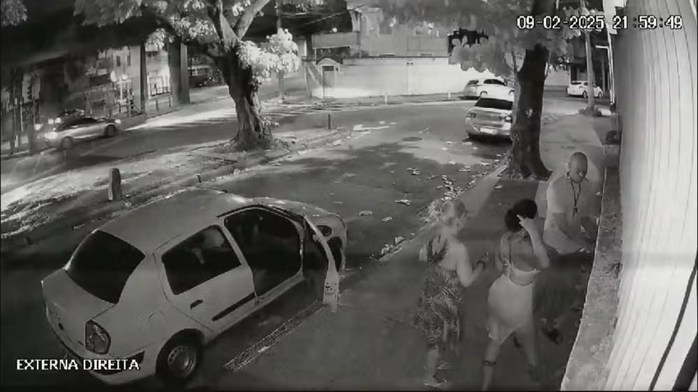 Um homem e duas mulheres chegaram em um carro branco. O homem tentou abrir o portão, mas não conseguiu de imediato.